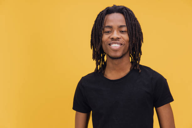 istock Young African American Man Smiling on Yellow Background 2195480068