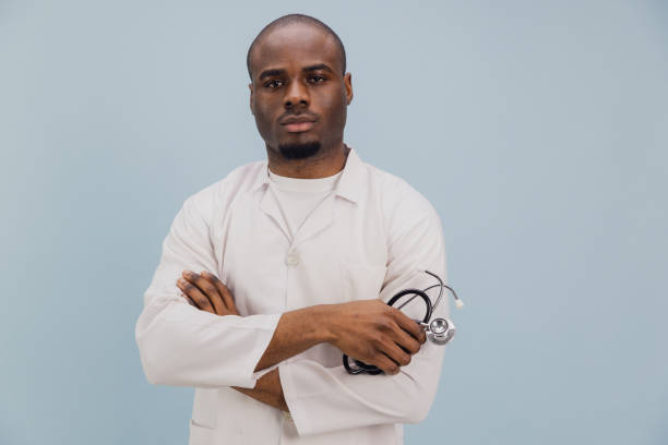 istock Confident African American Doctor Holding Stethoscope on Blue Background 2195480524