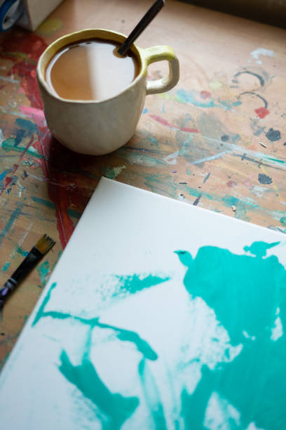 istock Coffee break while painting abstract art on canvas in art studio 2195480564