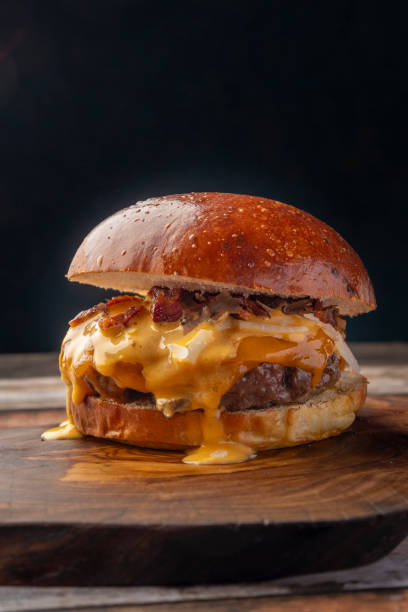 istock Delicious Cheeseburger with Bacon and Melted Cheese 2195480925