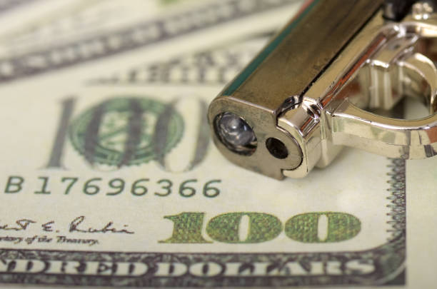 Conceptual Gun and American one hundred dollar bill