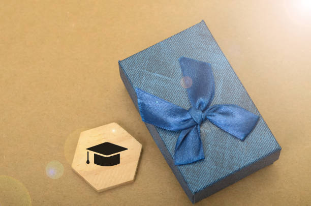 Elegant Blue Gift Box with Graduation Cap Symbol: Celebrating Academic Success