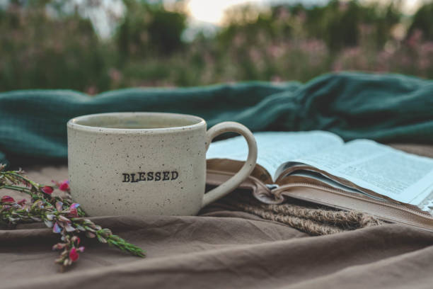 istock Cup with text BLESSED and open Bible in the garden, good morning 2195482399