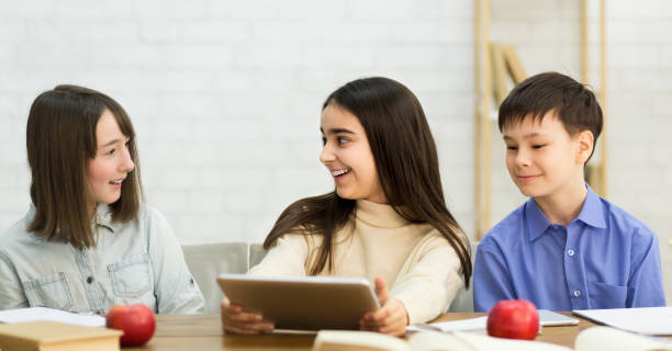 istock Shool Break. Happy Children Talking And Playing On Digital Tablet 2195484284