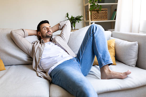 istock Serene man relaxing on comfortable sofa at home: finding peace and tranquility 2195485290