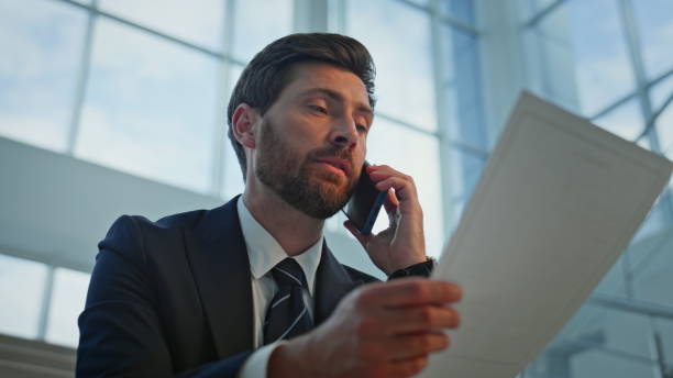 istock Calling businessman discussing document sitting office staircase closeup. 2195487096