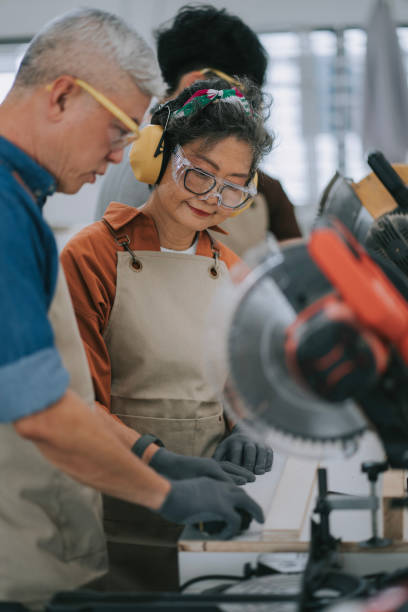 istock Asian senior woman learning from carpenter on woodwork classes workshop 2195488261