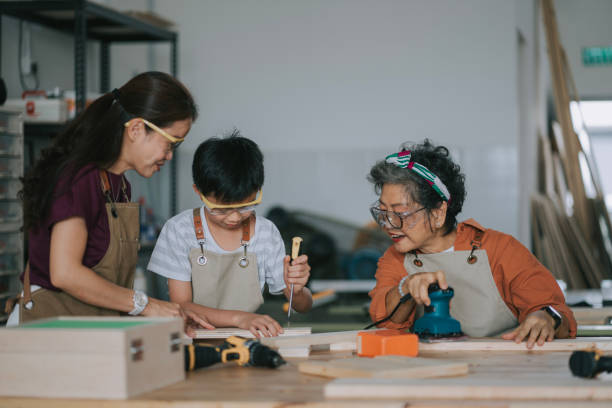istock Asian chinese multi generation family attending woodshop workshop during weekend 2195488533