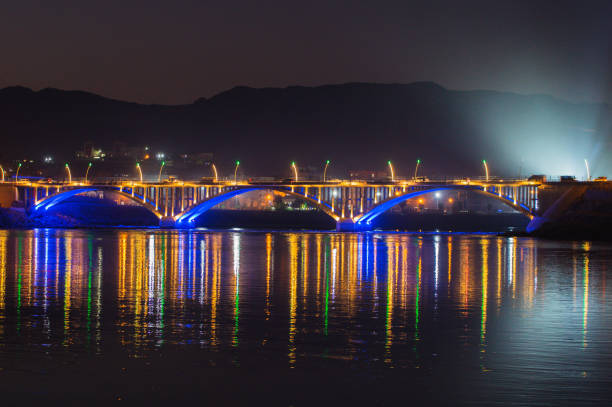 Reflection of lights on the Tigris River at sunset in Şırnak province - Cizre district and city view at night.\n04/04/2020