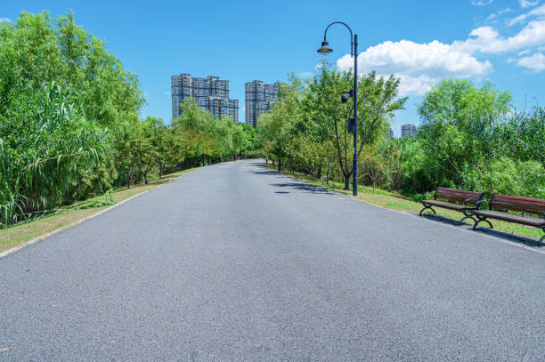 istock Curved pathway through the green city park 2195494606