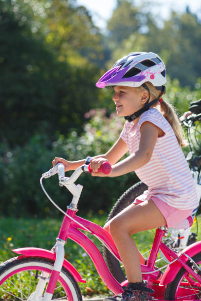 istock Little girl on bicycle in park 2195496057