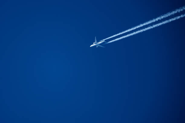 istock Airplane in the blue sky with trace of a passenger plane. 2195496537