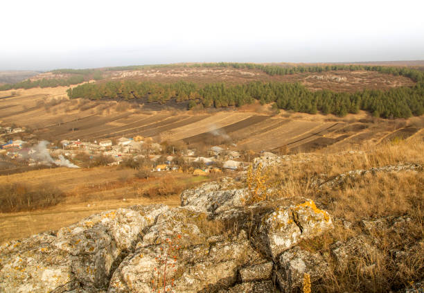 Rocky hills and houses: a beautiful landscape under a milky sky