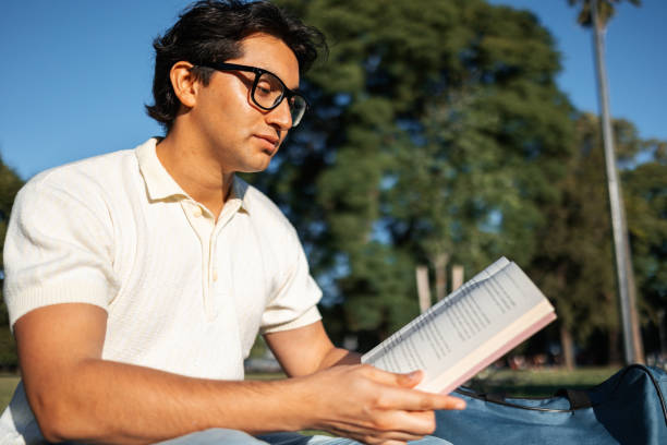 istock Person Enjoying a Relaxing Day While Reading a Book Outside 2195499037