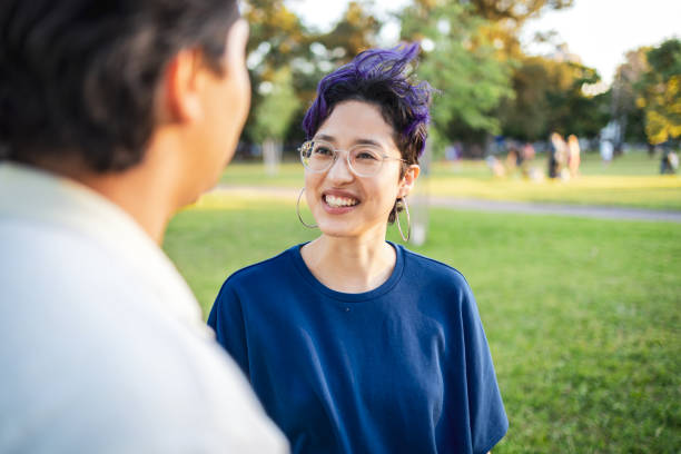 istock Two friends enjoying casual conversation outdoors in a park setting 2195499127
