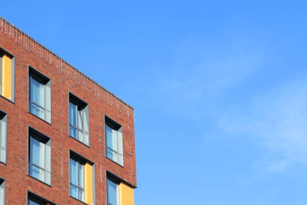 istock A stunning modern brick building stands proudly under a clear and vibrant blue sky 2195499336