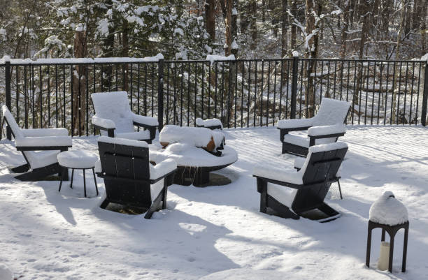 istock chairs around a fire pit covered in snow during winter (back yard backyard bbq burning ring with patio chair) table wintry scene closed for season blizzard 2195500441
