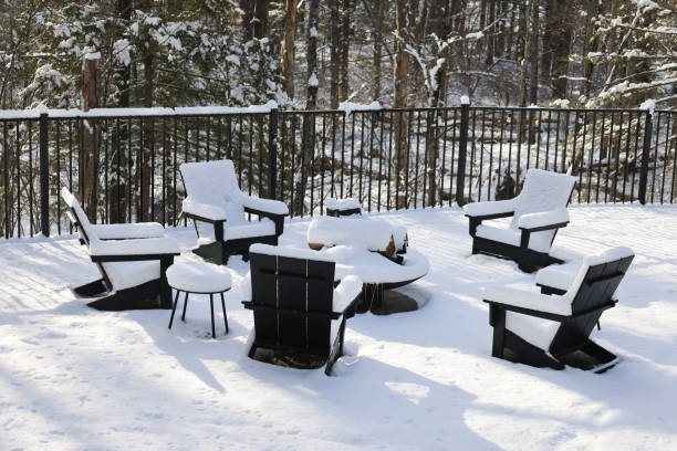 istock chairs around a fire pit covered in snow during winter (back yard backyard bbq burning ring with patio chair) table wintry scene closed for season blizzard 2195500480