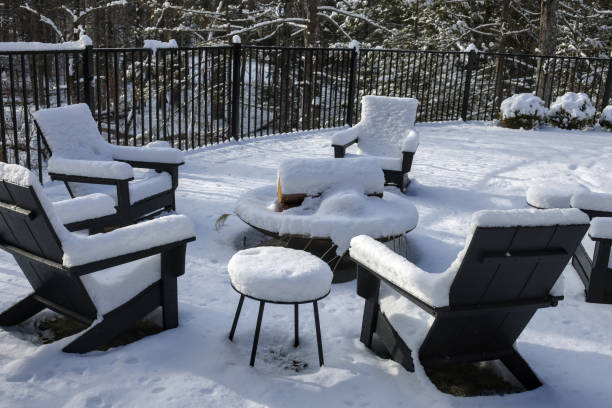 istock chairs around a fire pit covered in snow during winter (back yard backyard bbq burning ring with patio chair) table wintry scene closed for season blizzard 2195500745