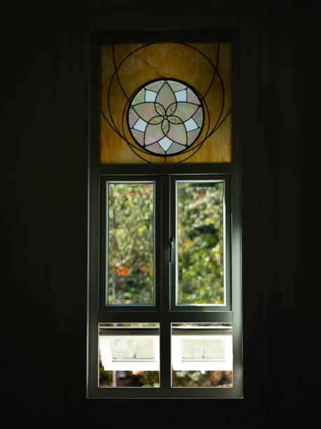 istock White windows in church with stained glass with various patterns decorating the top. 2195506069