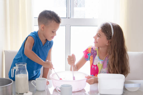 istock brothers kids mixing recipe at table 2195506980