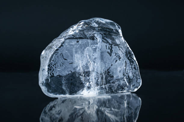 istock Natural  blue crystal clear  ice piece on black background with reflection 2195507651