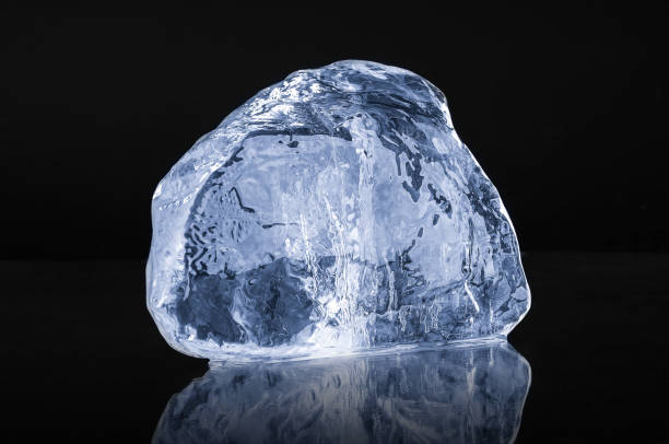 istock Natural  blue crystal clear  ice piece on black background with reflection 2195507659