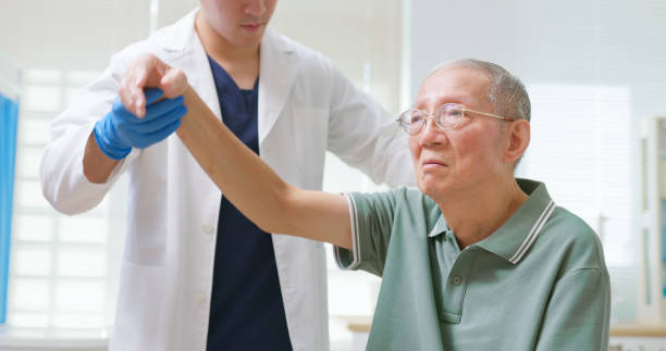istock Asian Therapist Aids Arm Recovery 2195515081