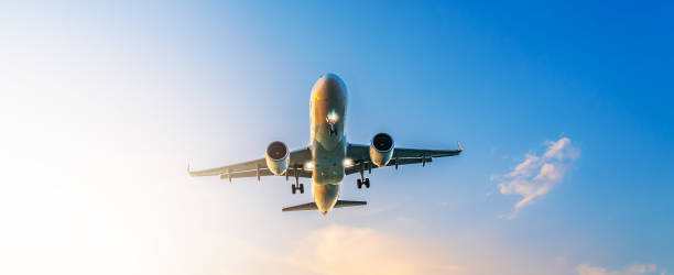 istock Airplane flying overhead against bright sky, symbolizing global travel, modern aviation, connection, freedom, technological progress, and worldwide exploration opportunities 2195517498