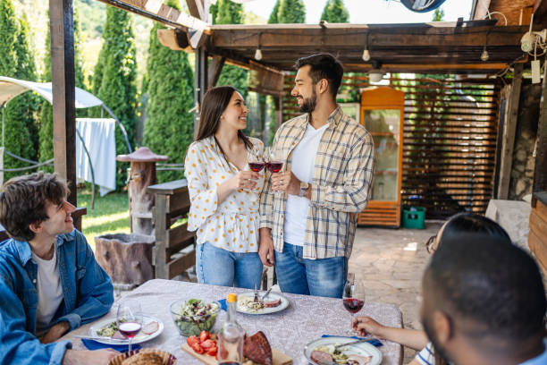 istock Couple hosts their friends for lunch in the backyard 2195518340