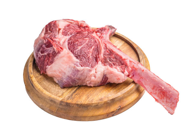 istock Uncooked tomahawk steak, raw black angus beef rib eye with bone on wooden board Isolated on a white background. top view 2195518855