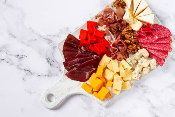 istock Assorted cheese on a wooden board, with grapes and walnuts, appetizer, no people. 2195521857