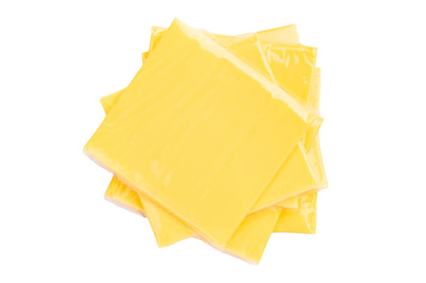 istock Square  Slices of processed Cheddar cheese in individual plastic packaging isolated on white background 2195522029
