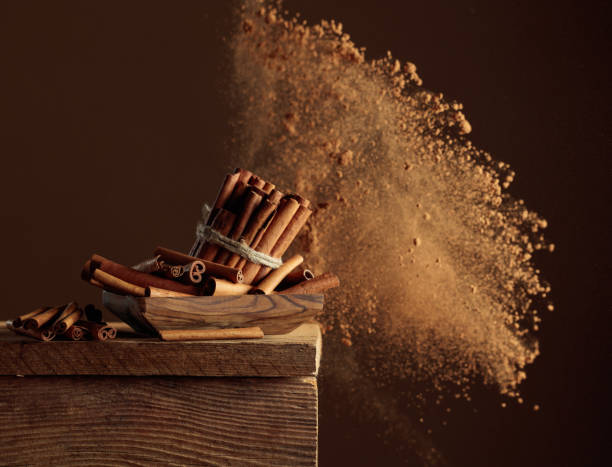 istock Cinnamon sticks and powder on a brown background. 2195522144