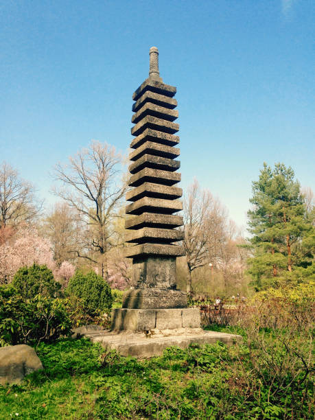 istock Zen garden stone tower with sakura blossoms under bright clear sky 2195522766
