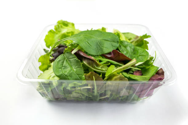 istock Fresh vegetarian salad - arugula, spinach, red spinach, lettuce isolated on white background. Image of different useful leaves in a plastic tray on white. 2195523113