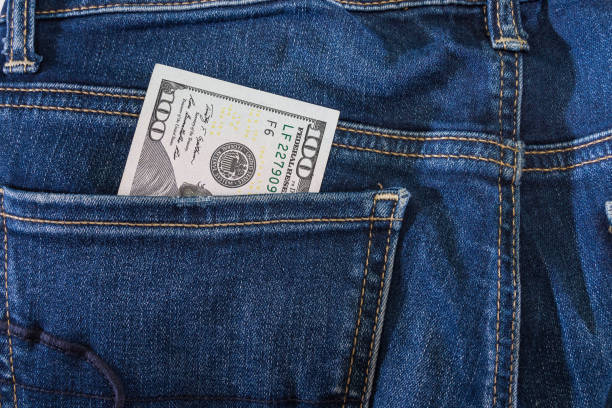 istock dollars in jeans pocket. Close-up. 2195525884