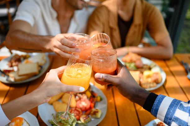 istock Diverse Friends Toasting Fresh Juices at Breakfast Table 2195526148