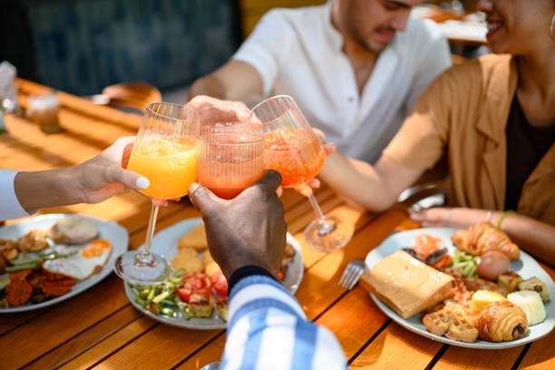 istock Diverse Friends Toasting with Fresh Juice at Breakfast 2195526152