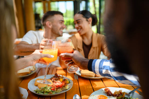 istock Diverse Friends Toasting with Juice at Breakfast Table 2195526167