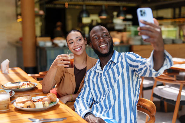 istock Multiracial Couple Enjoying Breakfast Selfie with Friends 2195526200