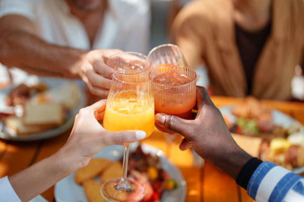 istock Diverse Friends Toasting with Fresh Juice at Breakfast 2195526222