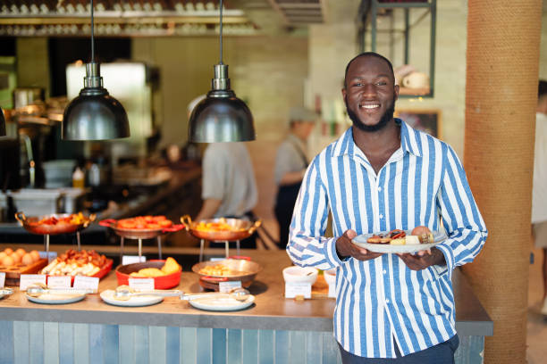 istock Smiling Black Man Enjoys Self-Service Restaurant Meal 2195526256