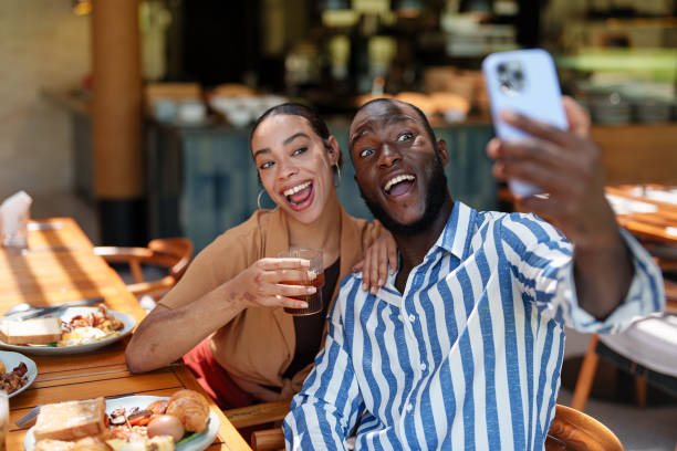 istock Joyful Multiracial Couple Taking Selfie at Breakfast Cafe 2195526312