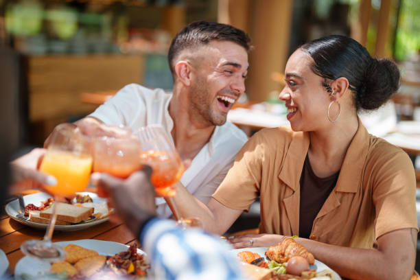 istock Joyful Couple Toasting with Friends at Cozy Breakfast 2195526317