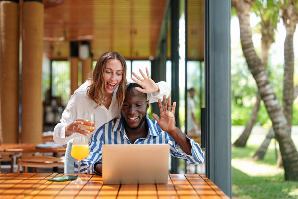 istock Diverse Entrepreneurs Video Chatting at Tropical Bar 2195526355