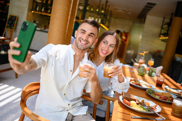 istock Smiling Couple Enjoying Breakfast in Cozy Cafe 2195526365