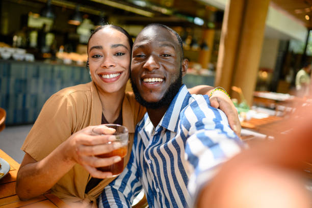 istock Joyful Couple Enjoying Breakfast at Cozy Cafe 2195526375
