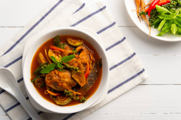 istock Spicy Catfish clear curry.Thai Jungle Curry with catfish and eggplant with fingerroot (Gaeng Pa),Thai hot and spicy curry soup without Coconut Milk in white bowl. 2195527345