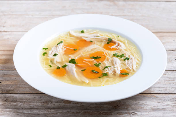 istock Homemade chicken soup on wooden table 2195527886